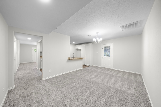 8355 Glencrest St, Houston, TX 77061 - unfurnished living room with carpet flooring, a chandelier, recessed lighting, and a textured ceiling
