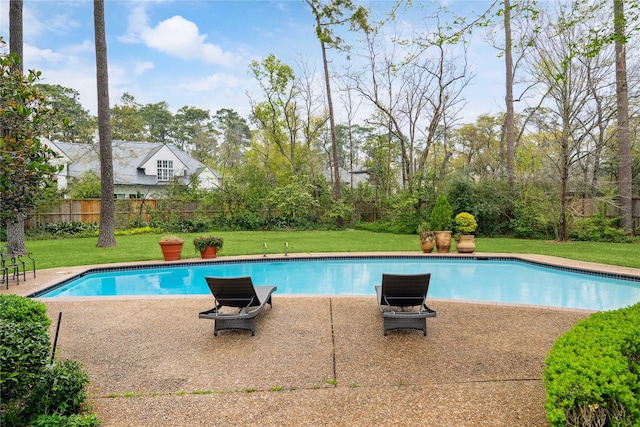 view of pool with a yard, a patio area, a fenced in pool, and fence