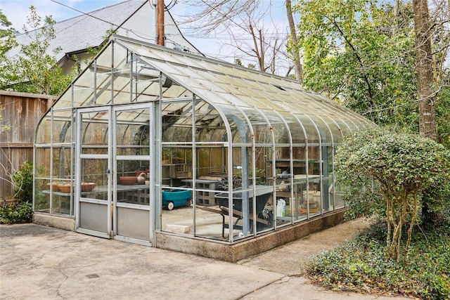 view of greenhouse featuring fence