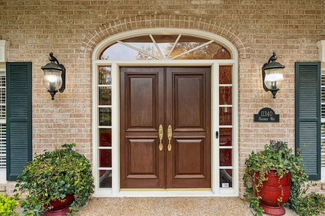 doorway to property with brick siding