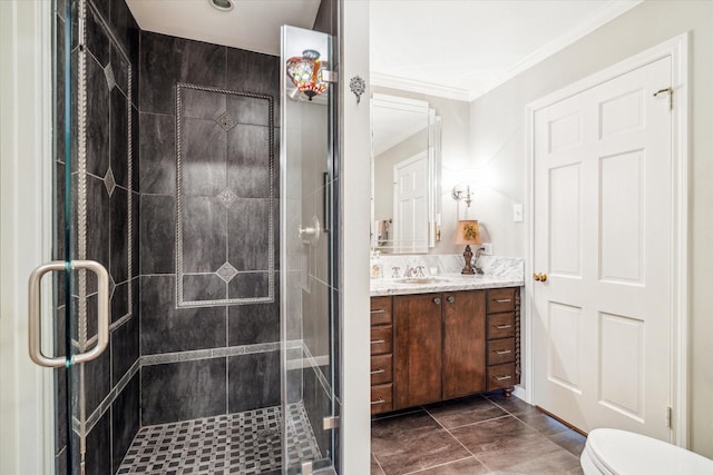 bathroom with vanity, a shower stall, toilet, and ornamental molding