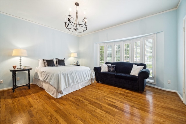 bedroom with multiple windows, an inviting chandelier, wood finished floors, and crown molding