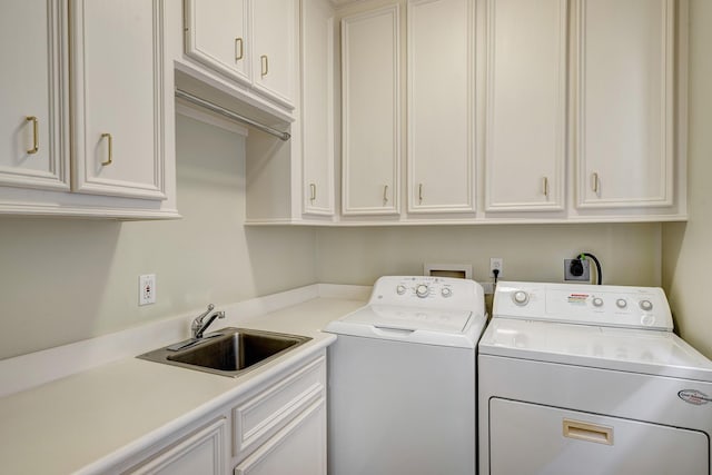 laundry room featuring a sink, cabinet space, and washing machine and clothes dryer