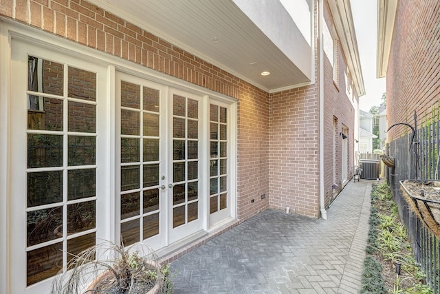 view of patio featuring french doors, central AC unit, and fence