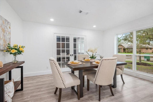 dining space with visible vents, recessed lighting, french doors, light wood-style floors, and baseboards