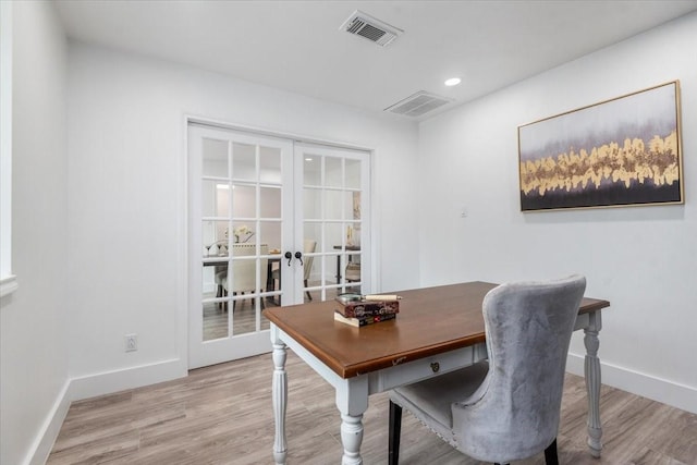 office featuring visible vents, french doors, baseboards, and wood finished floors