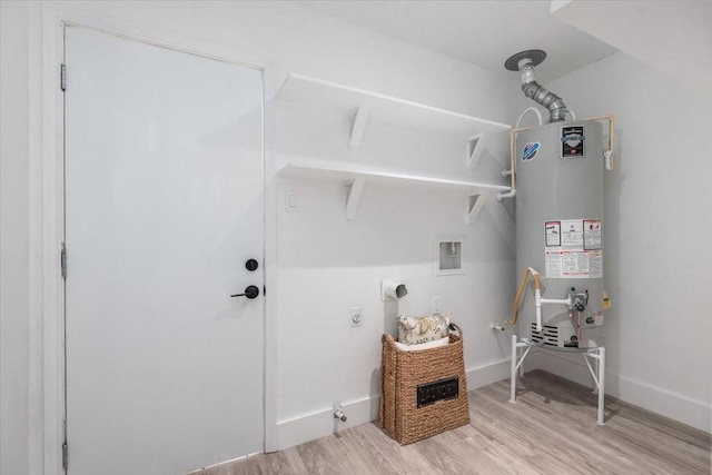 laundry room with baseboards, gas water heater, light wood-type flooring, laundry area, and electric dryer hookup