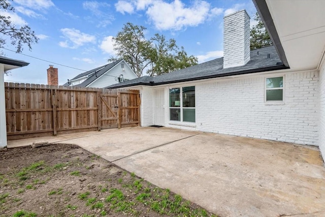 view of patio with a gate and fence