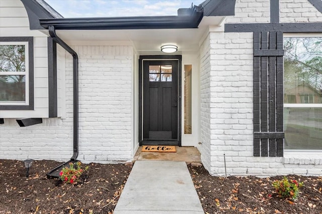 property entrance featuring brick siding