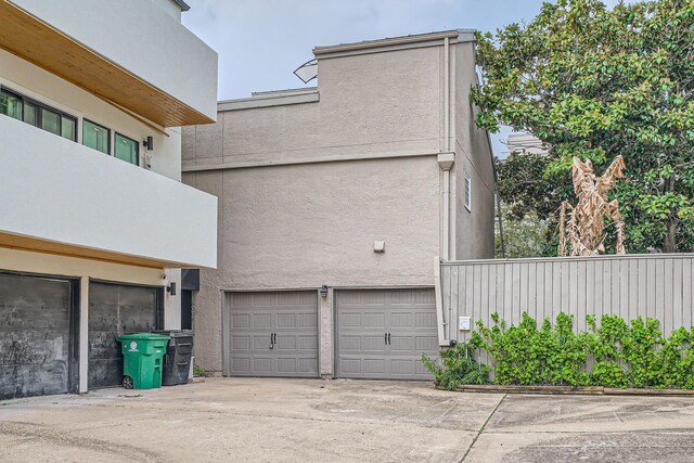 6008 Inwood Dr, Houston, TX 77057 - view of side of property with an attached garage, stucco siding, and driveway