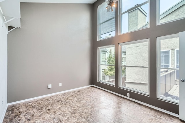 6008 Inwood Dr, Houston, TX 77057 - interior space featuring baseboards, a ceiling fan, and a healthy amount of sunlight