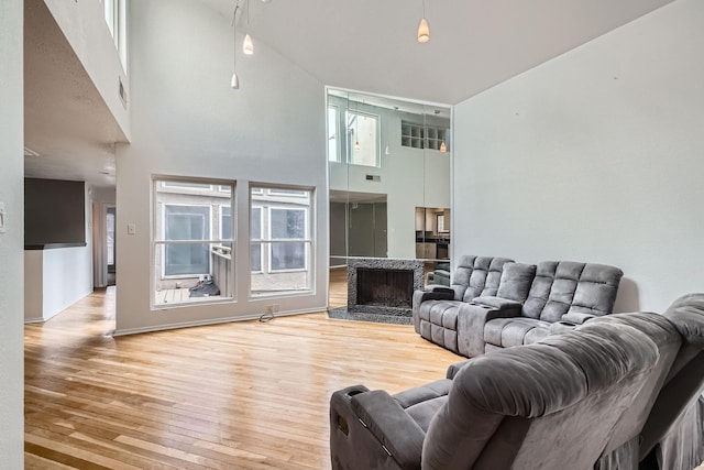 6008 Inwood Dr, Houston, TX 77057 - living room featuring a fireplace, a high ceiling, visible vents, and hardwood / wood-style floors
