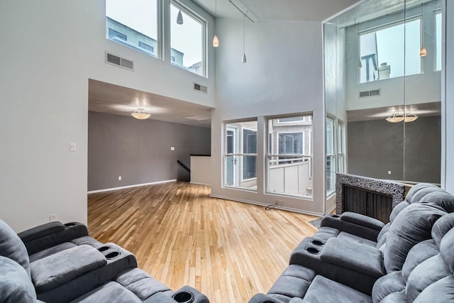 6008 Inwood Dr, Houston, TX 77057 - living area featuring visible vents, a towering ceiling, and hardwood / wood-style flooring