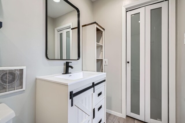 6008 Inwood Dr, Houston, TX 77057 - bathroom featuring visible vents, wood finished floors, and vanity