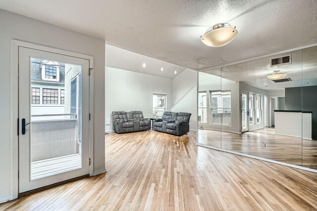 6008 Inwood Dr, Houston, TX 77057 - interior space featuring visible vents, a textured ceiling, light wood finished floors, and baseboards
