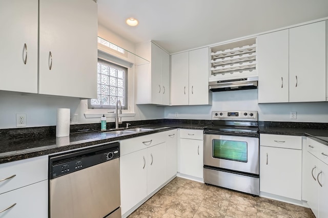 6008 Inwood Dr, Houston, TX 77057 - kitchen with appliances with stainless steel finishes, a sink, white cabinets, dark stone counters, and under cabinet range hood