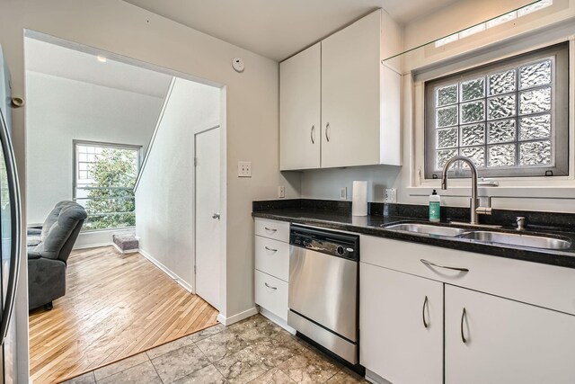 6008 Inwood Dr, Houston, TX 77057 - kitchen featuring stainless steel dishwasher, baseboards, dark stone counters, white cabinetry, and a sink