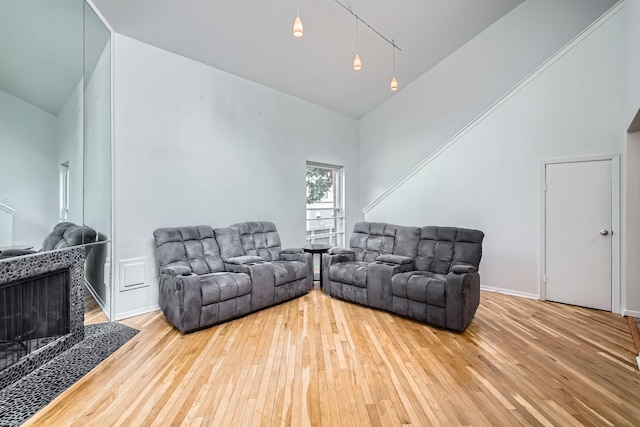 6008 Inwood Dr, Houston, TX 77057 - living room featuring rail lighting, hardwood / wood-style flooring, and high vaulted ceiling