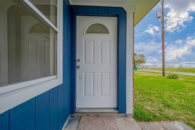 entrance to property with a yard