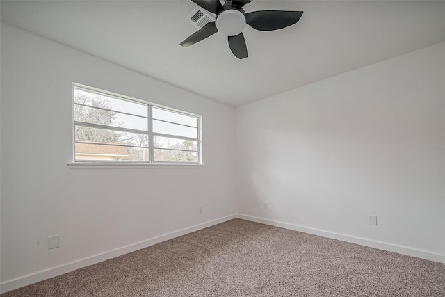 carpeted empty room with visible vents, baseboards, and a ceiling fan