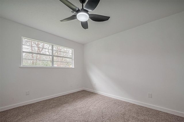 carpeted spare room with baseboards and ceiling fan