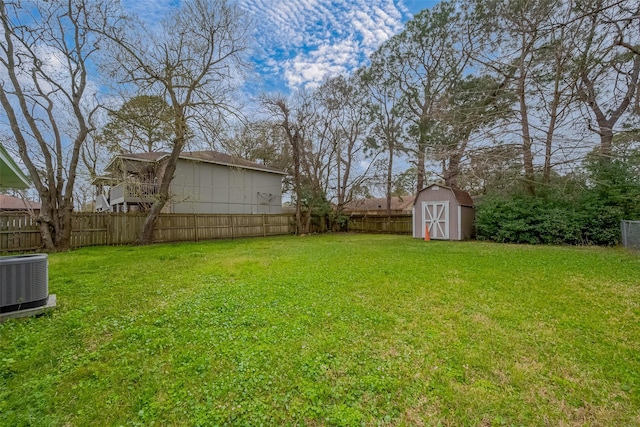 view of yard with cooling unit, a fenced backyard, a storage shed, and an outdoor structure