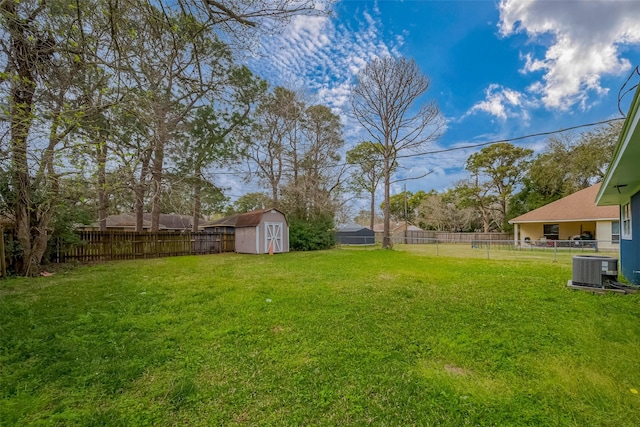 view of yard with cooling unit, a fenced backyard, a storage shed, and an outdoor structure