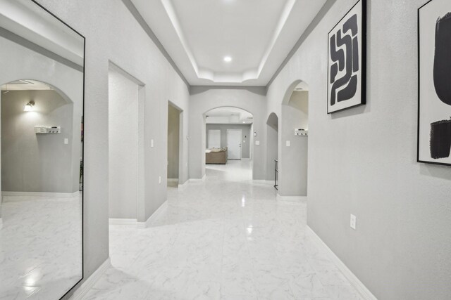 298 County Road 3545, Cleveland, TX 77327 - hallway with arched walkways, marble finish flooring, and baseboards