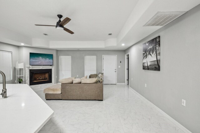 298 County Road 3545, Cleveland, TX 77327 - living area featuring a fireplace, a ceiling fan, marble finish flooring, recessed lighting, and baseboards