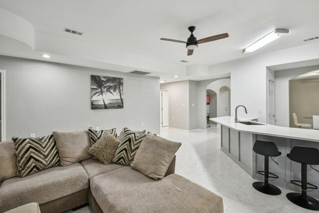 298 County Road 3545, Cleveland, TX 77327 - living area with arched walkways, a ceiling fan, light marble finish flooring, and recessed lighting