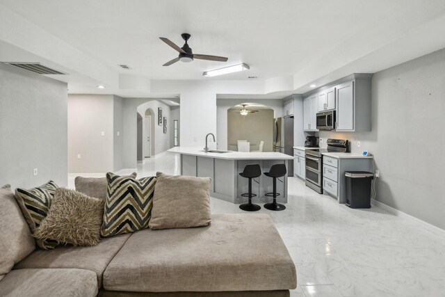 298 County Road 3545, Cleveland, TX 77327 - living room featuring arched walkways, ceiling fan, baseboards, light marble finish flooring, and recessed lighting