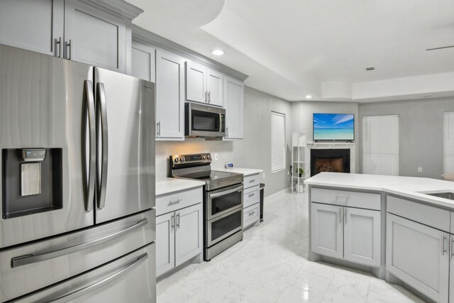 298 County Road 3545, Cleveland, TX 77327 - kitchen featuring stainless steel appliances, gray cabinets, light marble finish flooring, recessed lighting, and open floor plan