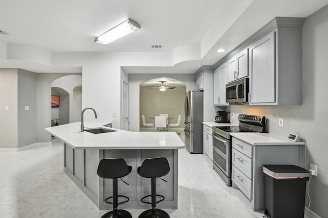 298 County Road 3545, Cleveland, TX 77327 - kitchen with stainless steel appliances, a sink, light marble finish floors, arched walkways, and recessed lighting