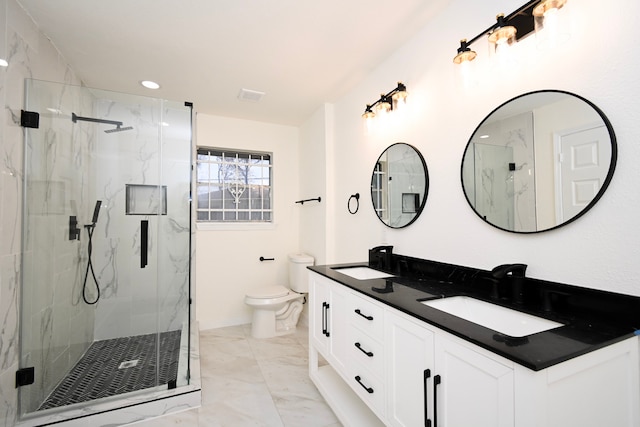 bathroom with toilet, marble finish floor, a marble finish shower, and a sink