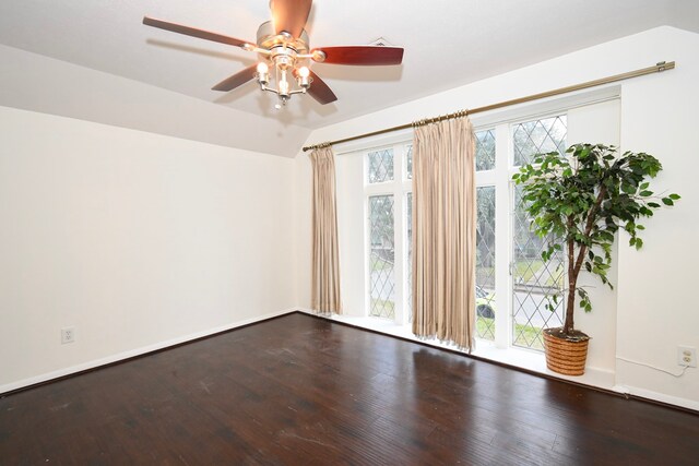 unfurnished room featuring a ceiling fan, vaulted ceiling, wood finished floors, and baseboards