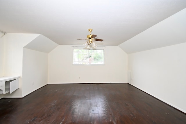 bonus room featuring vaulted ceiling, baseboards, a ceiling fan, and wood finished floors
