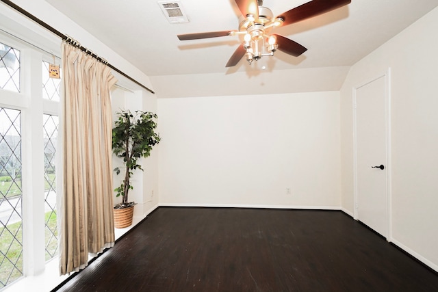 spare room with wood finished floors, a healthy amount of sunlight, visible vents, and ceiling fan