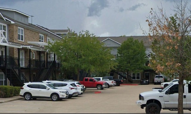 uncovered parking lot featuring stairs