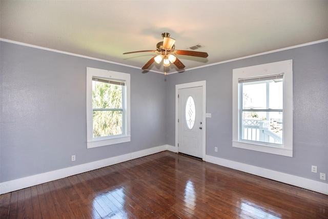 entrance foyer featuring a ceiling fan, baseboards, visible vents, hardwood / wood-style flooring, and crown molding