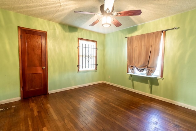 1922 Tabor St, Houston, TX 77009 - unfurnished room with a textured ceiling, a ceiling fan, dark wood finished floors, and baseboards