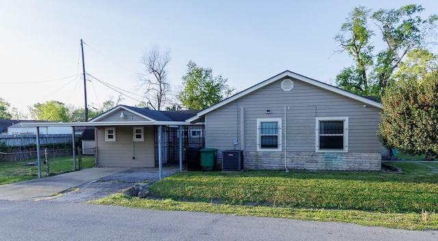 1922 Tabor St, Houston, TX 77009 - view of front of property featuring driveway, stone siding, an attached carport, and central AC unit
