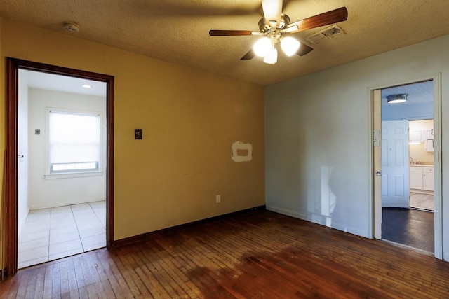 1922 Tabor St, Houston, TX 77009 - spare room featuring ceiling fan, dark wood-type flooring, baseboards, a textured ceiling, and a smoke detector