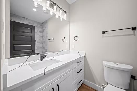 8120 Colonial Ln, Houston, TX 77051 - bathroom with vanity, toilet, and baseboards