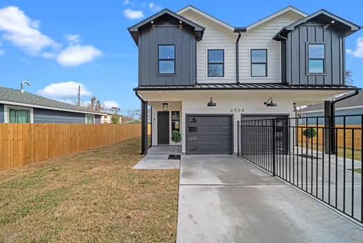 8120 Colonial Ln, Houston, TX 77051 - view of front of property with concrete driveway, board and batten siding, an attached garage, and fence