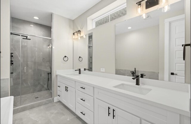 bathroom featuring double vanity, recessed lighting, a stall shower, and a sink