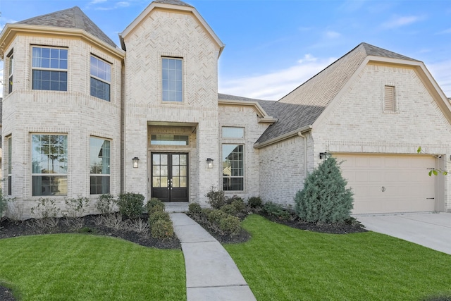 17366 Camillia Trl, Conroe, TX 77302 - french country inspired facade with french doors, brick siding, a front lawn, and driveway