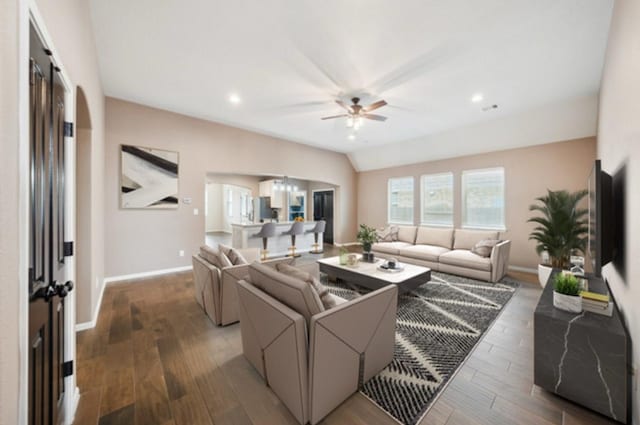 living area featuring ceiling fan, wood finished floors, baseboards, recessed lighting, and arched walkways