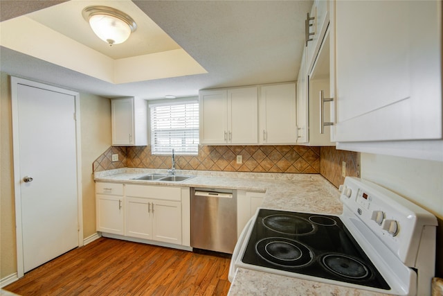kitchen featuring light countertops, dishwasher, white range with electric stovetop, a sink, and light wood-type flooring