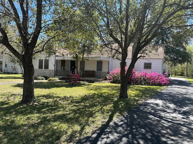 view of front of property with a front yard and a porch