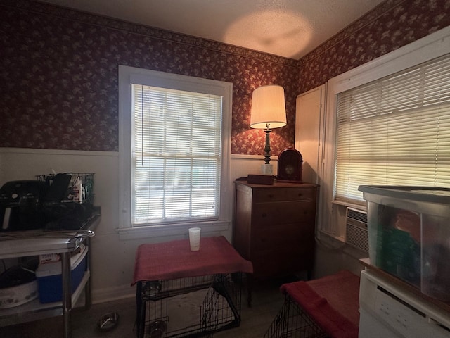 interior space with a wainscoted wall and wallpapered walls